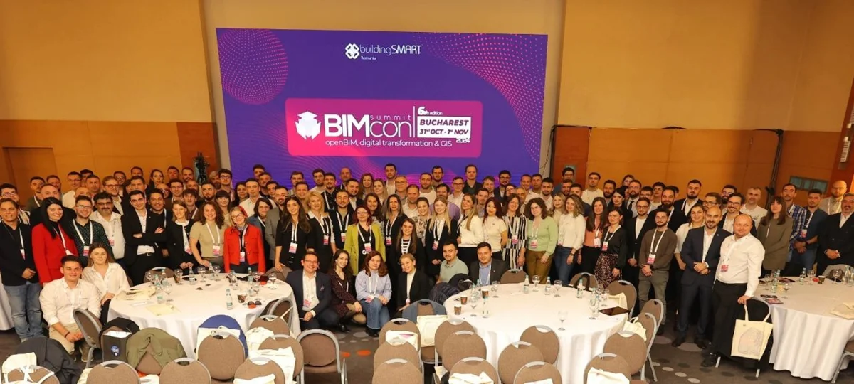 BIMcon 2024 participants gathered in front of the buildingSMART Romania event banner